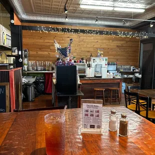 a table with a drink and menu