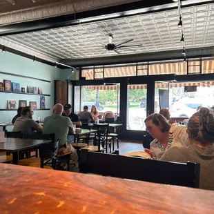 people sitting at tables in a restaurant