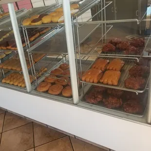 a variety of donuts in a display case