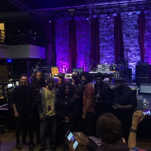 a group of people standing in front of a stage