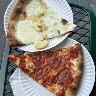 two slices of pepperoni pizza on paper plates