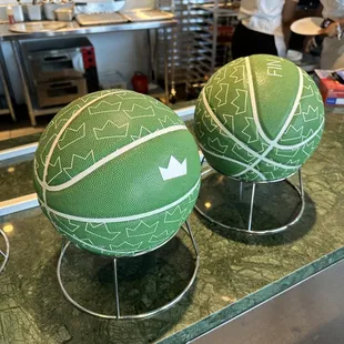 two green and white basketballs