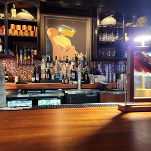 a wooden bar with bottles of alcohol