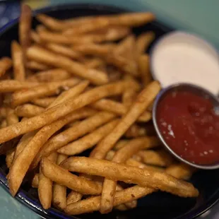a bowl of fries and ketchup