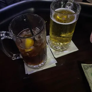 two glasses of beer and a dollar bill