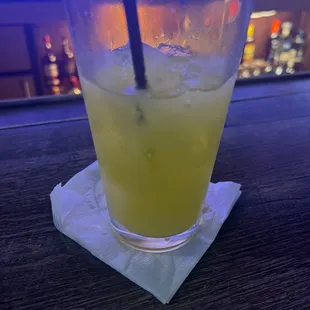 a glass of lemonade on a napkin