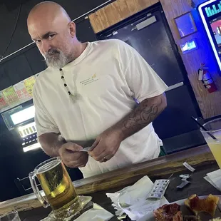 a man cutting a piece of pizza