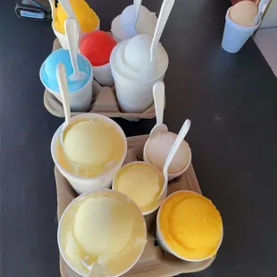 a tray of ice creams with spoons