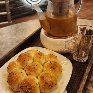 a plate of buns and a teapot