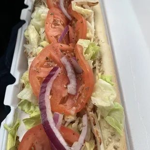 a sandwich with tomatoes and lettuce