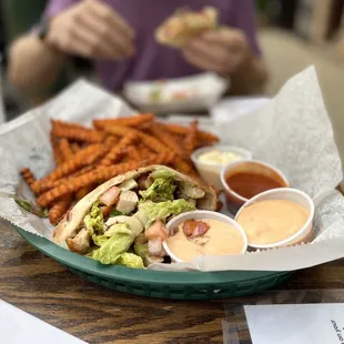 Pita wrap with sweet potato fries, mayonnaise, chipotle ranch, and a house made hot sauce.