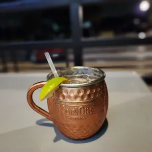 a copper mug with a lime slice in it