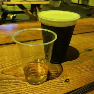 two cups of beer on a picnic table