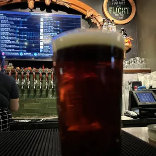 a pint of beer on a bar