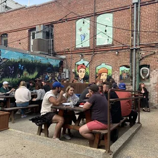 a group of people sitting at picnic tables