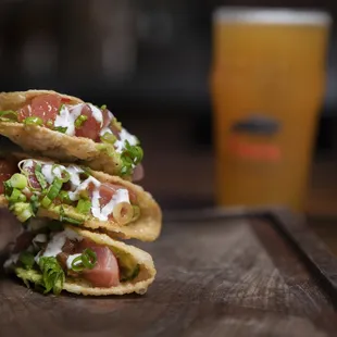 three tacos stacked on a cutting board