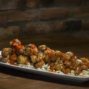 a plate of fried chicken with rice and carrots