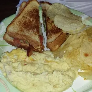 BLT Sandwich with potato salad and chips.