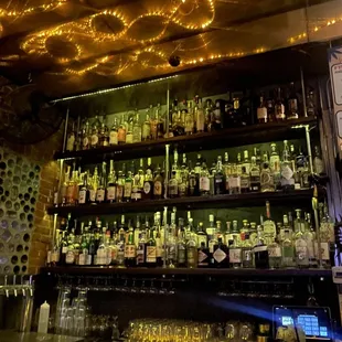 a bar with a lot of bottles on the shelves