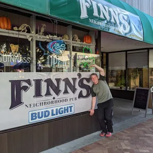 a woman standing in front of a store