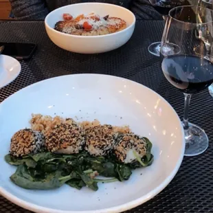 Sesame-Crusted scallops perfectly cooked on a bed of spinach with kimchi rice.