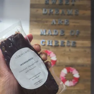 a hand holding a bag of chocolate