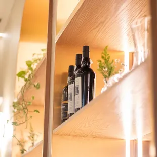 a shelf with bottles and plants