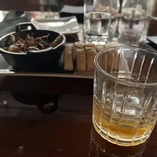  glass of beer and a plate of food