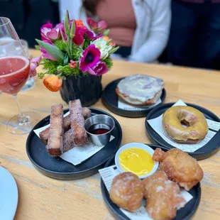 French Toast Sticks. Zeppole w/ Meyer lemon curd. Cinnamon Roll. Cake Donut w/ Passionfruit Glaze.