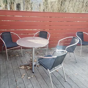 a table and chairs on a deck