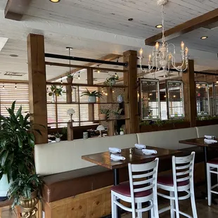 a dining area with a chandelier and tables