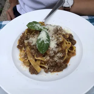 a plate of pasta with meat and cheese