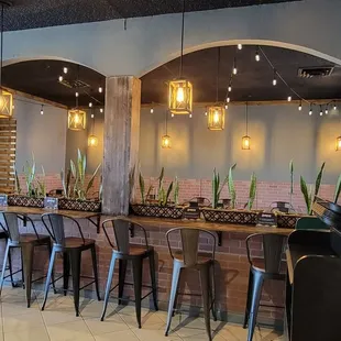 Two dining areas, one has tables, one is mostly counters with stools.  Cute!