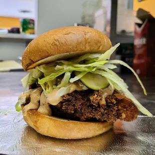 a chicken sandwich with lettuce and pickles