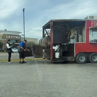 Angel doing what he does best serving the best BBQ and serving his community