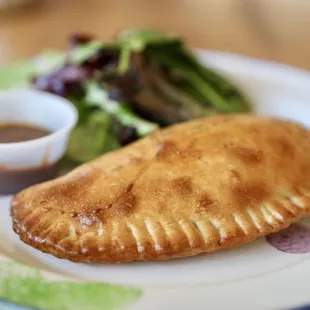 a plate of food with a side salad