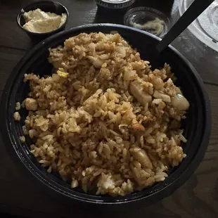 Barely any chicken and plate full of rice.