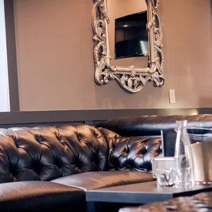 a leather couch and a mirror