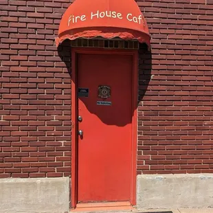 a red door with a red awning