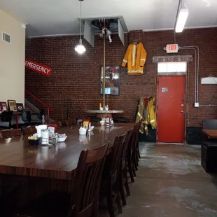 Entrance and long table with seating for a dozen people. Firemen still meet here for lunch.