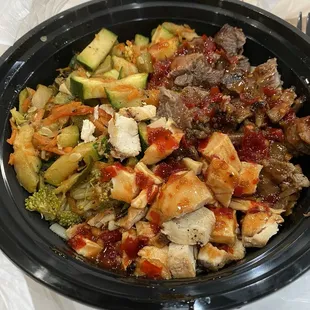 Bowl with noodles, chicken/steak combo, and spicy pineapple teriyaki