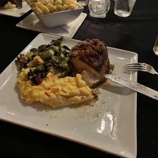 Pork chop with polenta and brussels.