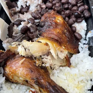a plate of rice, beans, and chicken