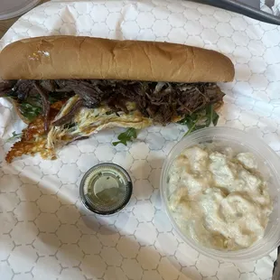 Beef brisket sub with a side of potato salad