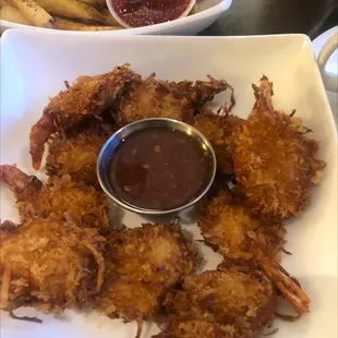 a plate of fried shrimp with dipping sauce