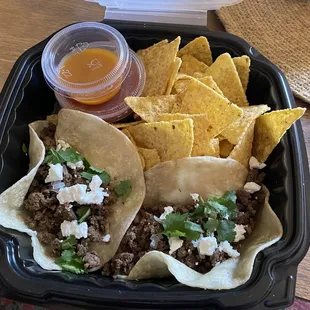 Beef tacos with goat cheese, chips and salsa with habanero hot sauce.