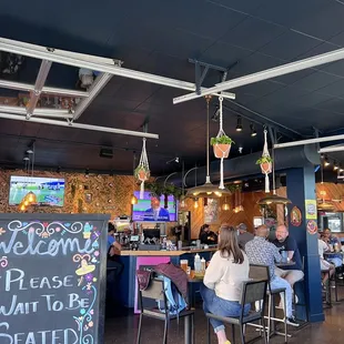 people sitting at tables in a restaurant