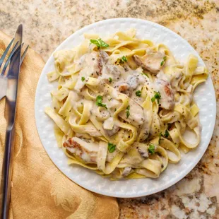 Creamy Homemade Alfredo Sauce Over a Bed of Fettuccine Pasta. Must Try!