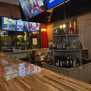 the bar and televisions in the background