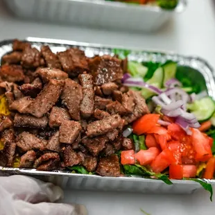 a tray of meat and vegetables